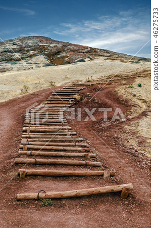 Old wooden stairs towards the top of the hill Old wooden stairs towards the top of the hill 46275733