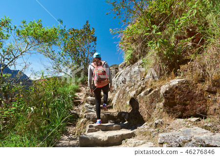 Woman with backpack doing trekking Woman with backpack doing trekking 46276846
