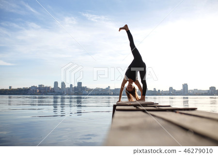 Young woman practicing yoga exercise at quiet Young woman practicing yoga exercise at quiet 46279010