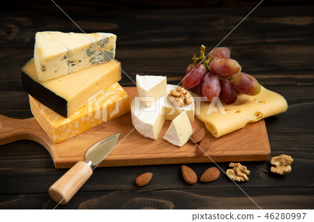 Various types of cheese on a rustic table 46280997