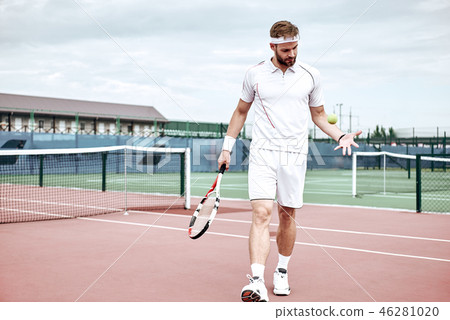 Portrait of young caucasian teenis player wearing tennis dress, walking on tennis hardcourt, summer Portrait of young caucasian teenis player wearing tennis dress, walking on tennis hardcourt, summer 46281020