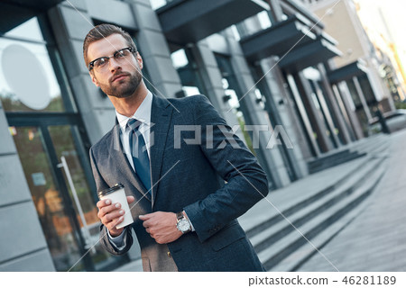Quick coffee break. Good looking young man in full suit and glas 46281189