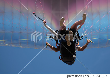 Paraglider tandem fly against the blue sky 46281304