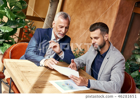 Business lunch. Two business people in the restaurant sitting at table discussing project joyful Business lunch. Two business people in the restaurant sitting at table discussing project joyful 46281651