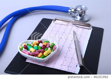Stethoscope, RX prescription and colorful assortment pills and capsules on plate. 46281992