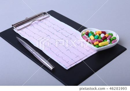RX prescription and colorful assortment pills and capsules on plate. 46281993