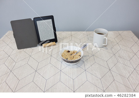 Electronic book and a cup of coffee on the table 46282384