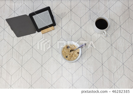 Electronic book and a cup of coffee on the table 46282385