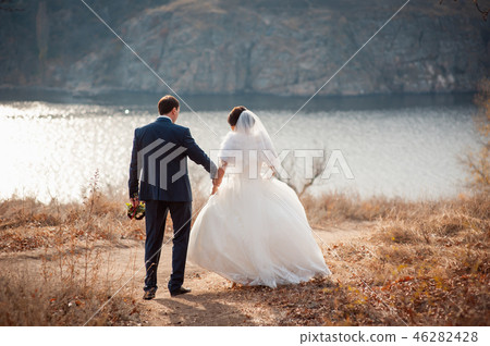 lovers is running with hold hands on city park lovers is running with hold hands on city park 46282428