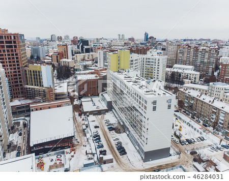 Snow covered city town and village houses in daylight with fresh snow and covered roofs. 46284031