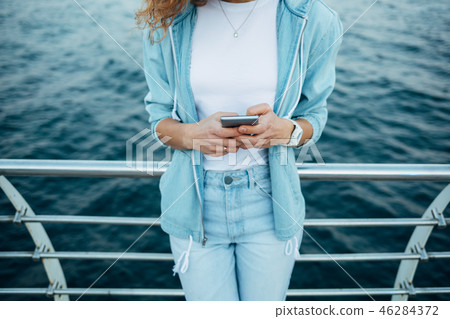 Young woman using smart phone Young woman using smart phone 46284372