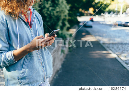 Young woman using smart phone outdoors 46284374