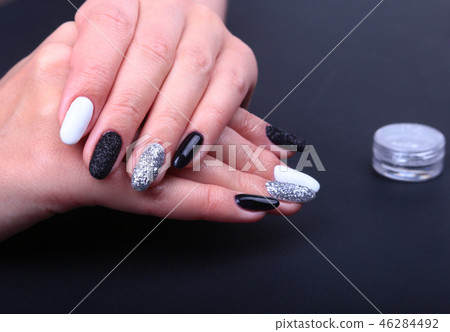Black, white Nail art manicure. Holiday style bright Manicure with sparkles. Beauty hands. Stylish 46284492