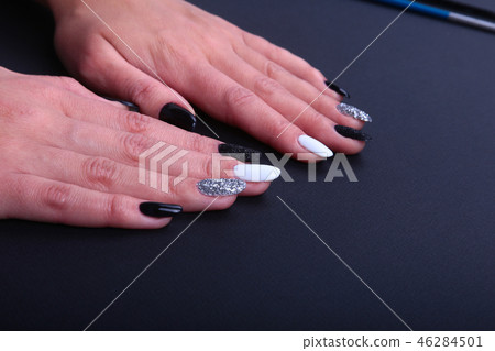 Black, white Nail art manicure. Holiday style bright Manicure with sparkles. Beauty hands. Stylish 46284501