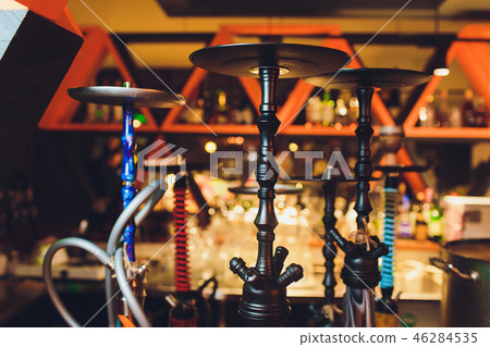 group of red hookahs shisha on table in interior. group of red hookahs shisha on table in interior. 46284535