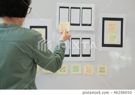 user experience UX designer designing web on mobile phone tablet layout. UI planning mobile application. developer work with business prototype user experience UX designer designing web on mobile phone tablet layout. UI planning mobile application. developer work with business prototype 46286050