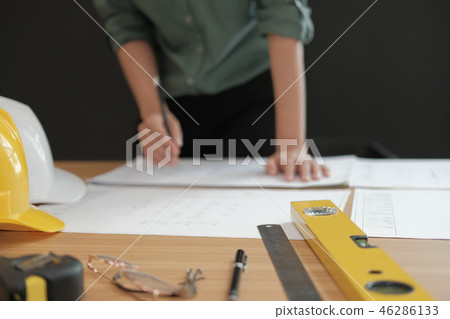 architect engineer working on house blueprint of real estate project at workplace. building construction concept architect engineer working on house blueprint of real estate project at workplace. building construction concept 46286133