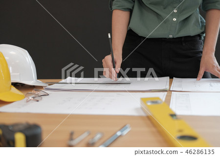 architect engineer working on house blueprint of real estate project at workplace. building construction concept architect engineer working on house blueprint of real estate project at workplace. building construction concept 46286135