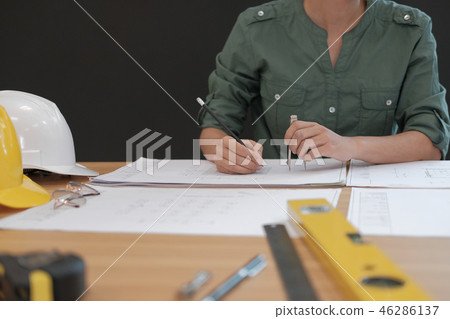 architect engineer working on house blueprint of real estate project at workplace. building construction concept 46286137