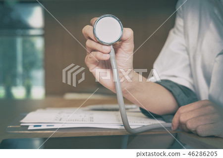 doctor physician medical practitioner with stethoscope to auscultate breath or checkup at clinic hospital 46286205