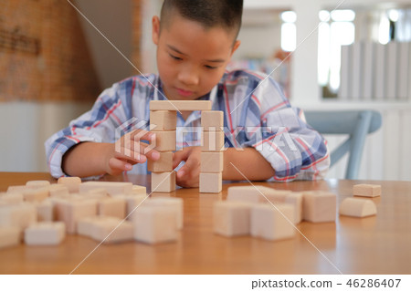 little asian kid boy child children schoolboy playing wood block toy. learning education concept little asian kid boy child children schoolboy playing wood block toy. learning education concept 46286407
