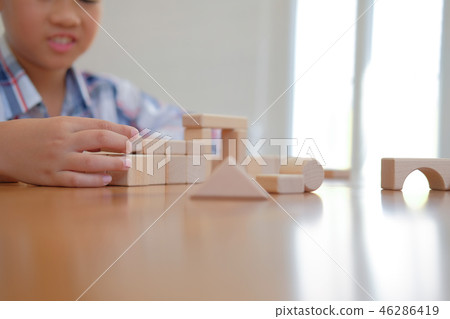 little asian kid boy child children schoolboy playing wood block toy. learning education concept little asian kid boy child children schoolboy playing wood block toy. learning education concept 46286419