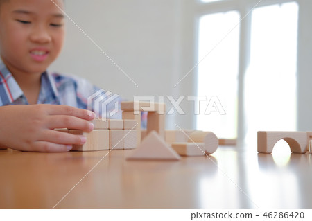 little asian kid boy child children schoolboy playing wood block toy. learning education concept little asian kid boy child children schoolboy playing wood block toy. learning education concept 46286420