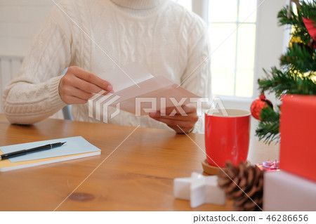 man opening sending christmas letter greeting card holiday wishes with xmas decoration man opening sending christmas letter greeting card holiday wishes with xmas decoration 46286656