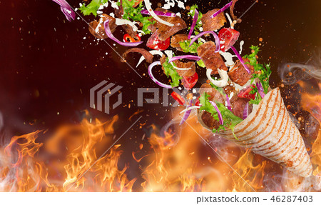 Kebab sandwich with flying ingredients. Kebab sandwich with flying ingredients. 46287403