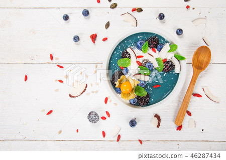 Smoothie bowl with fresh berries, nuts, seeds, fruit and vegetables. Smoothie bowl with fresh berries, nuts, seeds, fruit and vegetables. 46287434