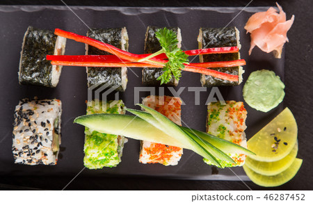 Japanese sushi set on a rustic dark background. Japanese sushi set on a rustic dark background. 46287452