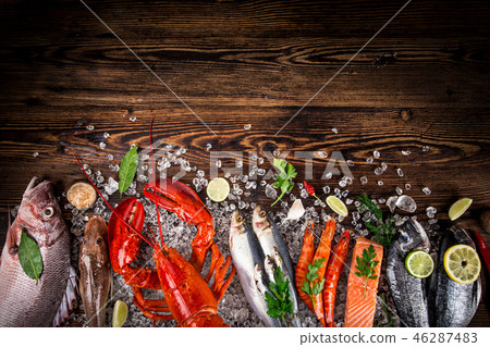 Fresh tasty seafood served on old wooden table. Fresh tasty seafood served on old wooden table. 46287483