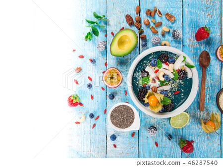Smoothie bowl with fresh berries, nuts, seeds, fruit and vegetables. Smoothie bowl with fresh berries, nuts, seeds, fruit and vegetables. 46287540