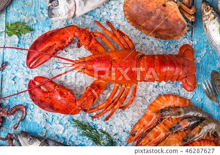 Fresh tasty seafood served on old wooden table. Fresh tasty seafood served on old wooden table. 46287627