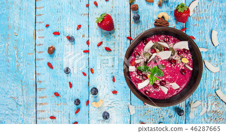 Smoothie bowl with fresh berries, nuts, seeds, fruit and vegetables. Smoothie bowl with fresh berries, nuts, seeds, fruit and vegetables. 46287665