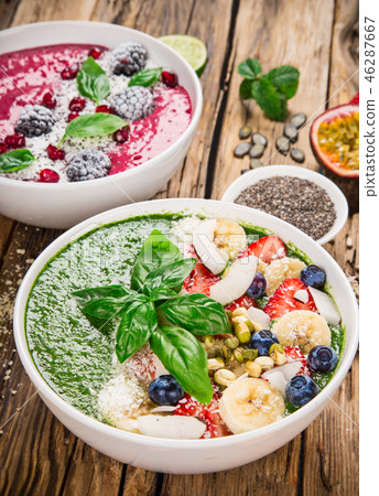 Smoothie bowl with fresh berries, nuts, seeds, fruit and vegetables. Smoothie bowl with fresh berries, nuts, seeds, fruit and vegetables. 46287667