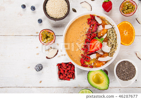 Smoothie bowl with fresh berries, nuts, seeds, fruit and vegetables. Smoothie bowl with fresh berries, nuts, seeds, fruit and vegetables. 46287677