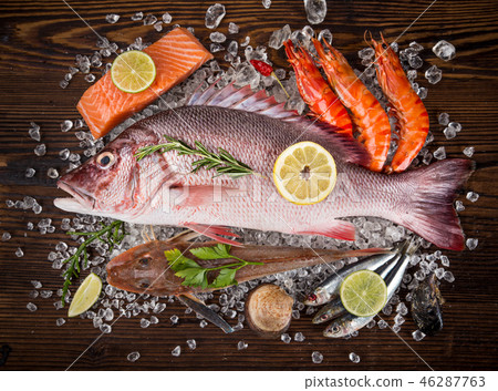 Fresh tasty seafood served on old wooden table. Fresh tasty seafood served on old wooden table. 46287763