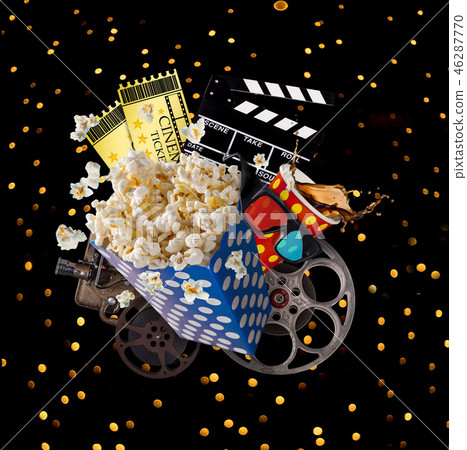 Pop-corn, movie tickets, clapperboard and other things in motion. Pop-corn, movie tickets, clapperboard and other things in motion. 46287770