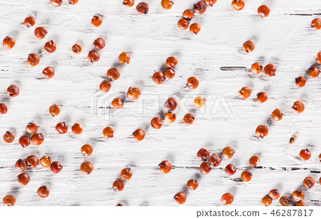 Red quinoa seeds on white wooden table. 46287817