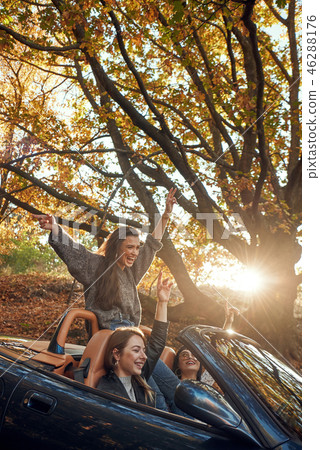 Portrait of three pretty young women in cabriolet 46288176