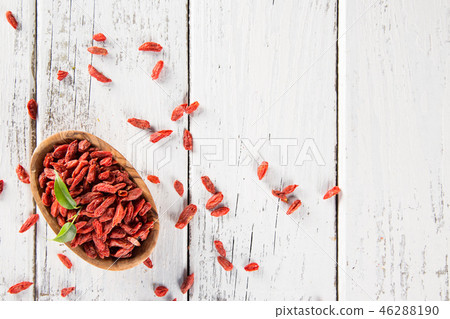 Dry goji berry on old white wooden background. Dry goji berry on old white wooden background. 46288190