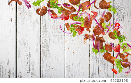 Kebab ingredients flying, close-up. Kebab ingredients flying, close-up. 46288198
