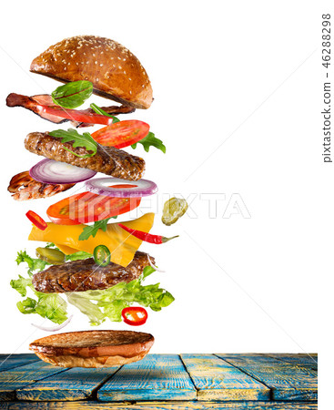 Big tasty burger with flying ingredients. 46288298
