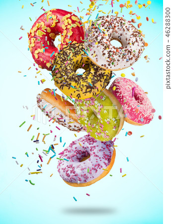Tasty doughnuts in motion falling on pastel blue background. 46288300