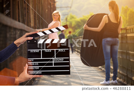 Clapperboard sign hold by female hands. Clapperboard sign hold by female hands. 46288811
