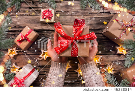 Top view of woman hands with gift box. Top view of woman hands with gift box. 46288814