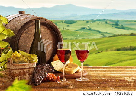 red wine bottle and wine glasses with wodden barrel 46289198