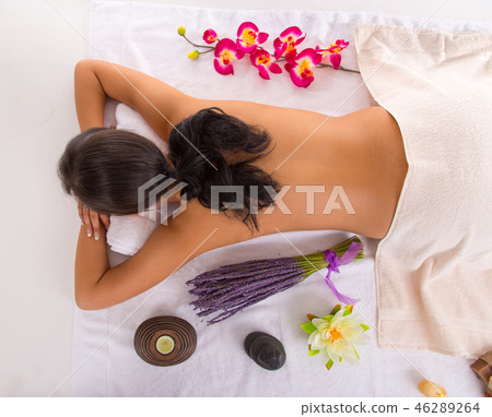 Young woman receiving hot stone massage 46289264