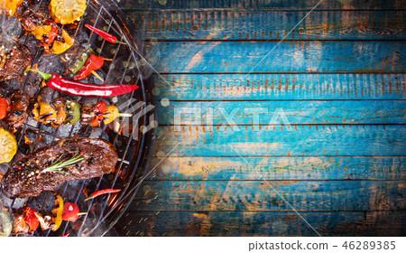 Barbecue grill with beef steaks, close-up. Barbecue grill with beef steaks, close-up. 46289385